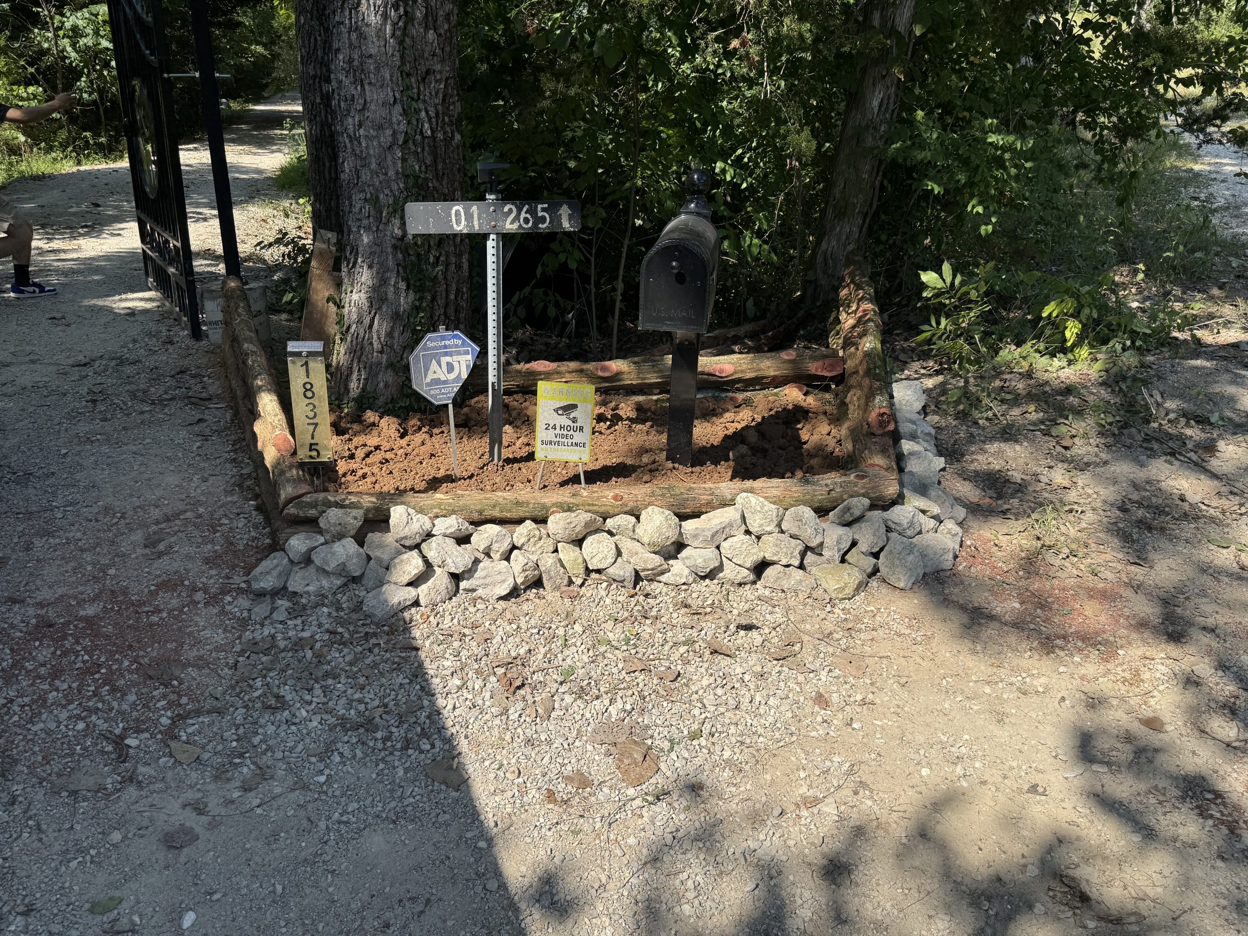 Mailbox bed and rock border landscaping